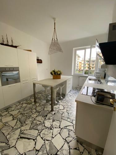 a kitchen with a table and a stone floor at La perla in Chiavari
