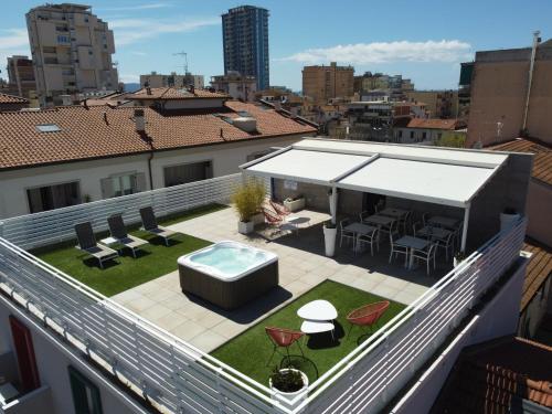 a rooftop patio with a hot tub on a roof at MARCONI 1935 in Follonica