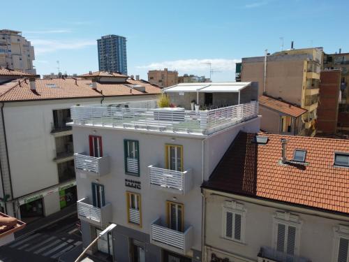 a white building with a balcony on top of it at MARCONI 1935 in Follonica