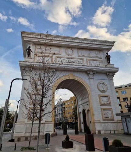 a building with an arch with statues on it at Hotel Macedonia Square in Skopje