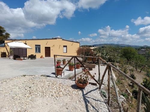 a house with two potted plants on the steps at Casa vacanze Sicilia in Casteltermini