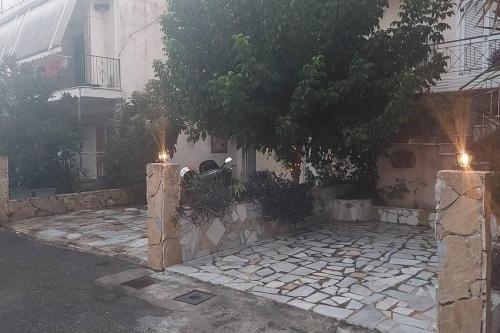 a house with two lights in front of a stone courtyard at Efi Studio 1 Lamia in Lamía