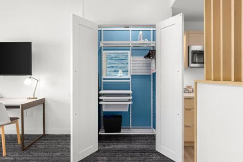 a room with a door leading to a kitchen with a window at TownePlace Suites by Marriott Cape Canaveral Cocoa Beach in Cape Canaveral