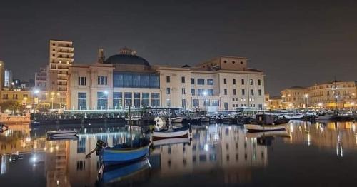 a group of boats docked in a harbor at night at B&B Romeo in Bari