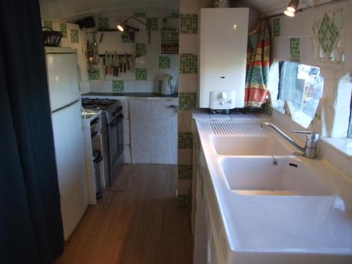 a kitchen with a white sink and a stove at Hébergement insolite nature/4 in Saint-André-de-Sangonis