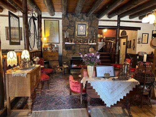 a living room with a table with a laptop on it at Inn of Glen Haven in Glen Haven