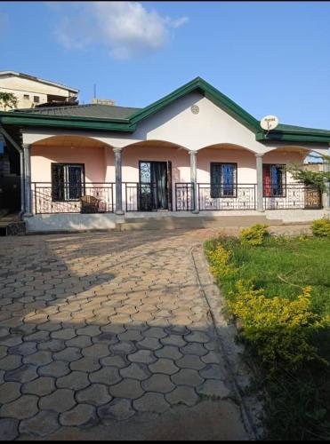 a house with a stone driveway in front of it at Résidence le HAMEAU de BITENG in Yaoundé