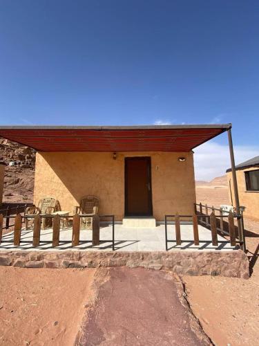 a building with a red roof in the desert at Yara camp in Wadi Rum