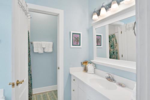 a white bathroom with a sink and a mirror at Boogie Man 36C By Pkrm in Pensacola