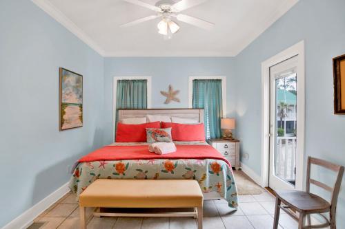 a bedroom with a red bed and a chair at Boogie Man 36C By Pkrm in Pensacola