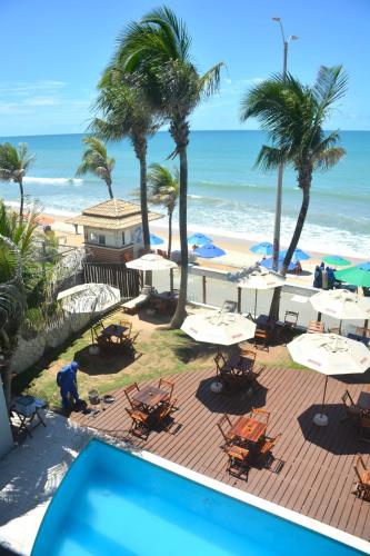 a view of the beach from the balcony of a resort at Apto Romântico frente mar vista mar Elegance Flat in Natal