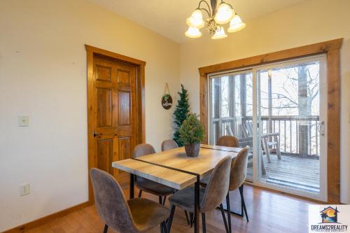 a dining room with a wooden table and chairs at Forest Heights Lodge - 6BR - Pool Table - Near Silver Dollar City - FREE TICKETS INCLUDED - in Branson