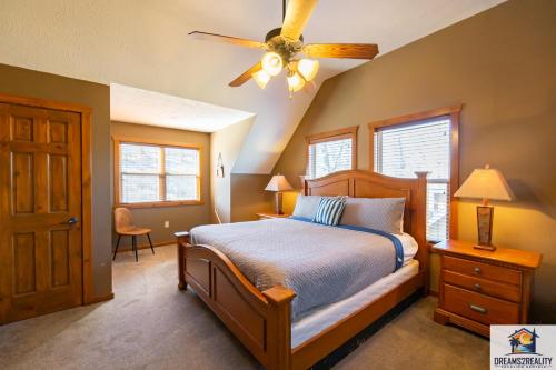 a bedroom with a bed and a ceiling fan at Forest Heights Lodge - 6BR - Pool Table - Near Silver Dollar City - FREE TICKETS INCLUDED - in Branson