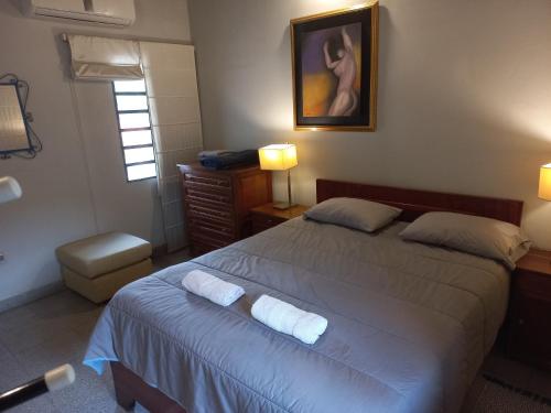 a bedroom with a bed with two towels on it at Amplio Departamento cerca de todo 3 Habitaciones in Asunción