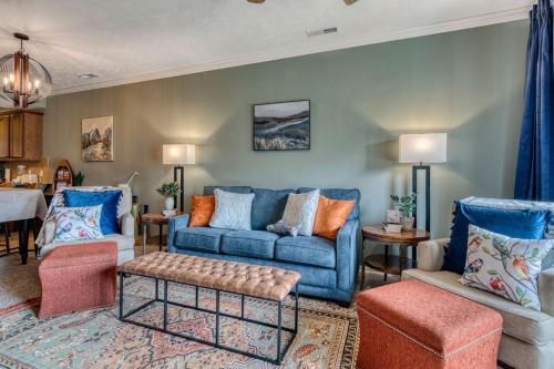 a living room with a blue couch and chairs at 2BR Condo - Dock for Fishing - Jacuzzi Tub - FREE TICKETS INCLUDED - MJ4-130 in Branson