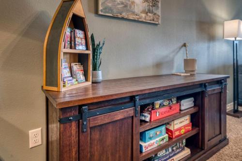 a wooden cabinet with a mirror and books at 2BR Condo - Dock for Fishing - Jacuzzi Tub - FREE TICKETS INCLUDED - MJ4-130 in Branson