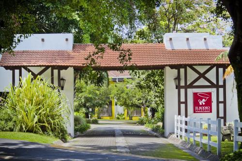 an entrance to a building with a red roof at El Rodeo Estancia Boutique Hotel & Steakhouse in San José