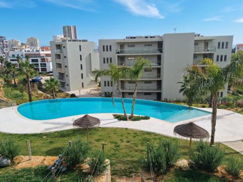 an empty swimming pool in front of a building at Maktub @ Oásis Mar in Portimão