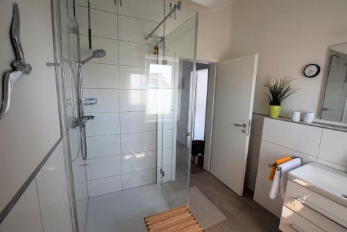 a bathroom with a shower with a glass shower stall at Meeresblick-Deck-44-Haus-3-WE-44 in Hohwacht