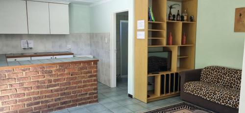 a living room with a couch and a brick wall at Thornycroft lodge in East London