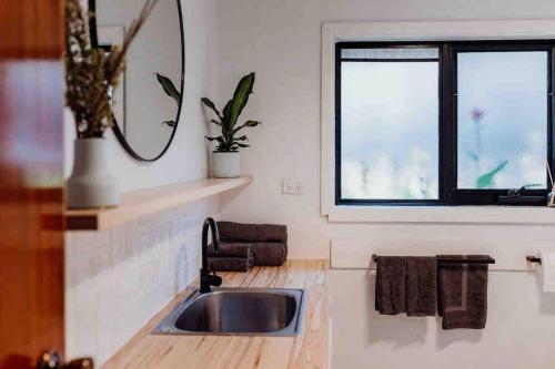 a kitchen with a sink and a window at Beach Haven Scamander in Scamander
