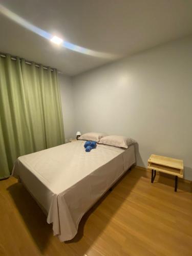 a bedroom with a bed and a light on the ceiling at Residencial Cayenne in Caxias do Sul