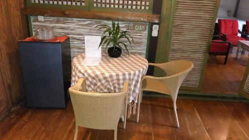 a table with chairs and a potted plant on it at Mi Casa - The gem of Ijen in Banyuwangi