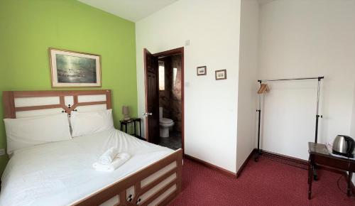 Lyttleton Lodge tesisinde bir odada yatak veya yataklar