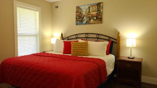 a bedroom with a bed with a red blanket and two lamps at 3BR Walk-In with Loft - Pool and Hot Tub - FREE TICKETS INCLUDED - PARA in Branson