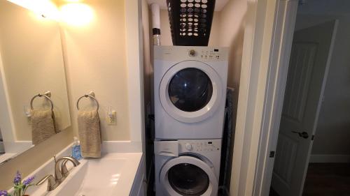 a washer and dryer in a bathroom next to a sink at 3BR Walk-In with Loft - Pool and Hot Tub - FREE TICKETS INCLUDED - PARA in Branson