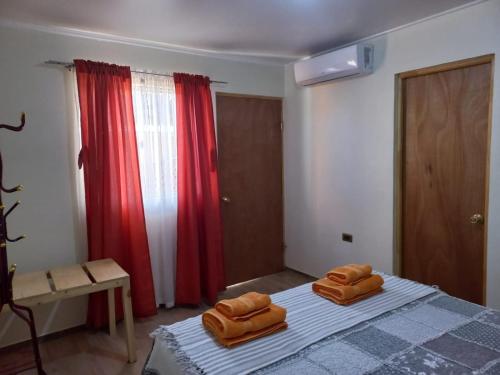 a bedroom with a bed with two brown pillows on it at hostal casa talitha in San Pedro de Atacama