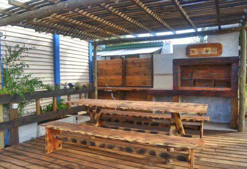 two wooden benches sitting on a wooden deck at CastefadelDiablo in Punta Del Diablo