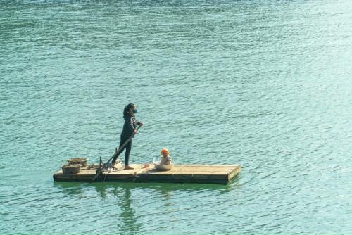 a woman standing on a dock in the water at Catba Central Hotel 2 in Cat Ba