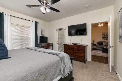 a bedroom with a bed and a flat screen tv at 3BR Walk-In - Close to Attractions - FREE TICKETS INCLUDED - RL4-2 in Branson