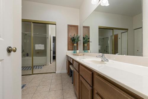 a bathroom with a sink and a large mirror at 3BR Walk-In - Close to Attractions - FREE TICKETS INCLUDED - RL4-2 in Branson