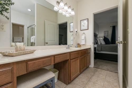 a bathroom with a sink and a large mirror at 3BR Walk-In - Close to Attractions - FREE TICKETS each day you stay - RL4-2 in Branson