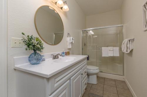 a bathroom with a sink and a toilet and a mirror at 3BR Walk-In - Close to Attractions - FREE TICKETS INCLUDED - RL4-2 in Branson