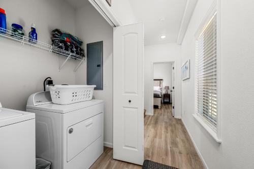 a laundry room with white cabinets and a hallway at 4BD Lodge at Table Rock Lake - Near Marina - Pool - BBH in Lampe