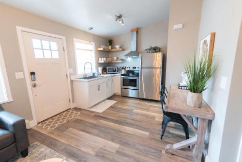 a kitchen with a table and a refrigerator at Colony Suites in Palmer