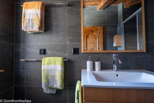 a bathroom with a sink and a mirror at Haus Zer Trächu in Saas-Almagell