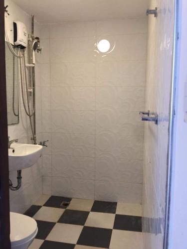 a bathroom with a shower with a sink and a toilet at 5 Min Walk To Famous Blue Water Resort And Tourist Area in Maribago