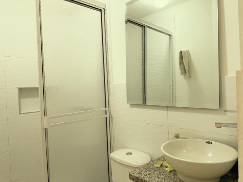 a bathroom with a shower and a sink and a toilet at Hotel Campestre Villa Mary in Santa Rosa de Cabal