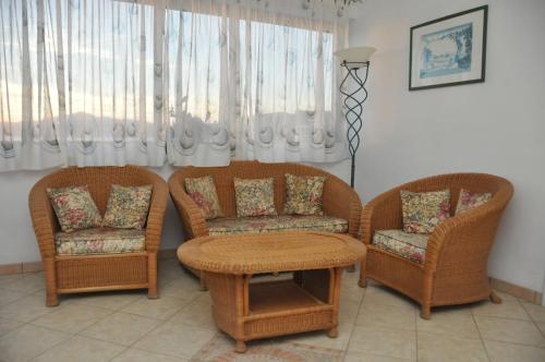 a living room with two chairs and a table at Appartamenti Villa Miramare in Capoliveri