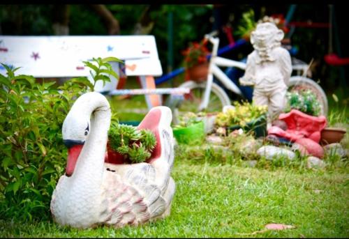 a statue of two swans sitting in the grass at Apartmani LANA Podgorica in Podgorica
