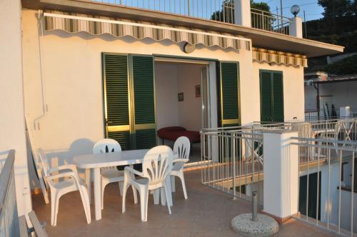 a patio with a table and chairs on a balcony at Appartamenti Villa Miramare in Capoliveri