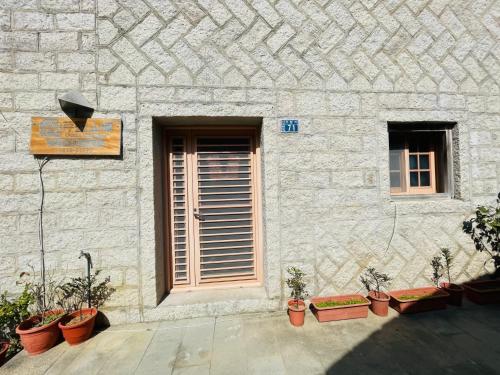 a building with a door and a bunch of potted plants at 芹壁山城民宿 Chinbe Hill Village House B&B in Beigan