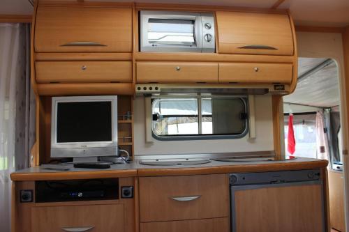 Ein Wohnwagen mit einem Computer und einem Fernseher darin in der Unterkunft Caravan 't Koekoeksnest in Aagtekerke