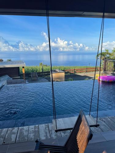 a swimming pool with a view of the ocean at Dodo House auberge de jeunesse in Saint-Leu