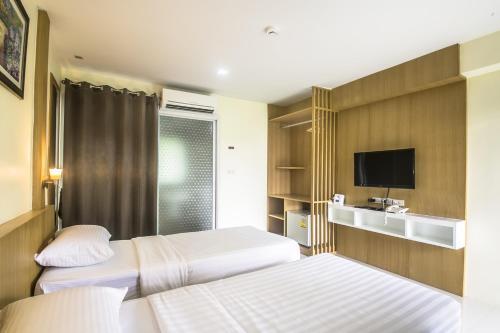 Ένα ή περισσότερα κρεβάτια σε δωμάτιο στο Petchsiri Boutique Hotel เพชรสิริ บูทิค