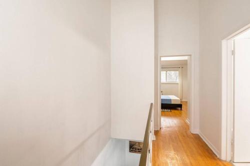 a hallway with white walls and a stair case at Harmony Home Near University of Waterloo in Waterloo